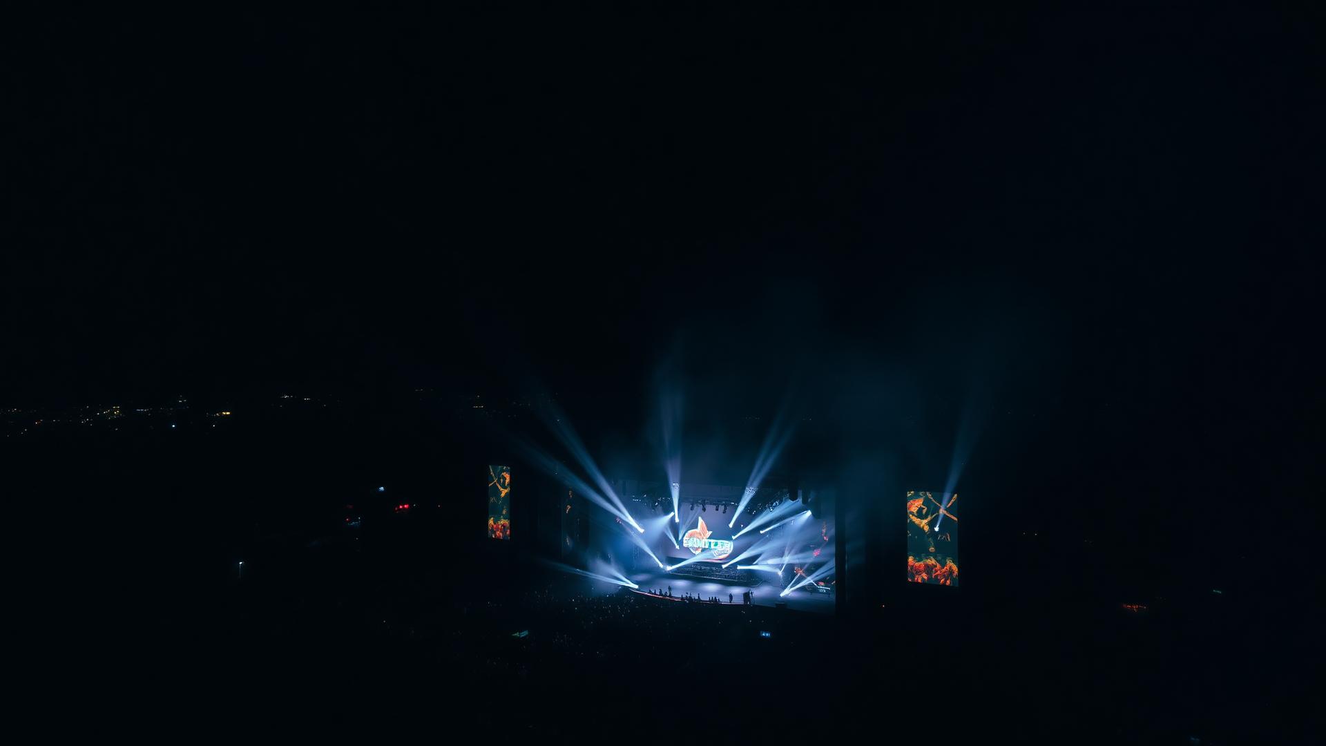 Festival stage lighting in atmospheric haze